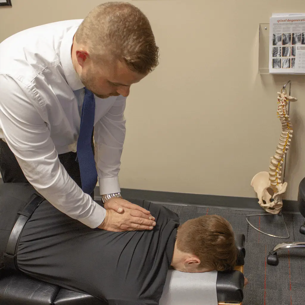 Chiropractor performing a back adjustment on a patient in Shoreview, MN