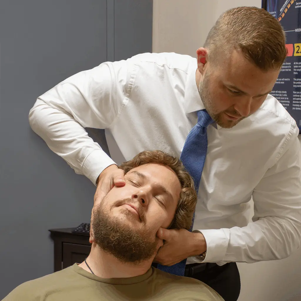 Dr. Andrew Krueger performing a chiropractic neck adjustment in Shoreview
