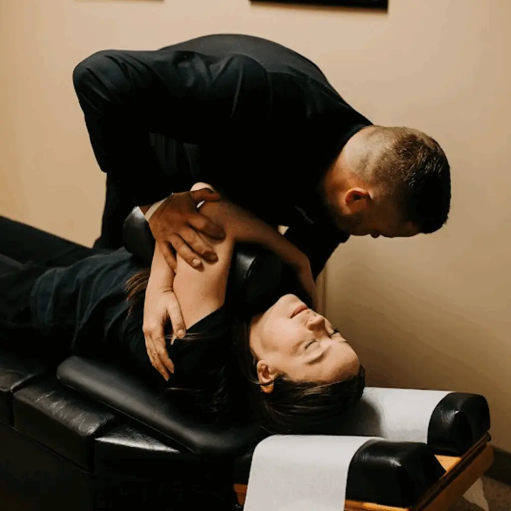 Dr. Andrew Krueger performing a spinal adjustment