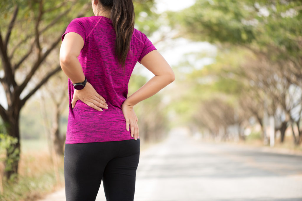 woman feel pain in her lower back