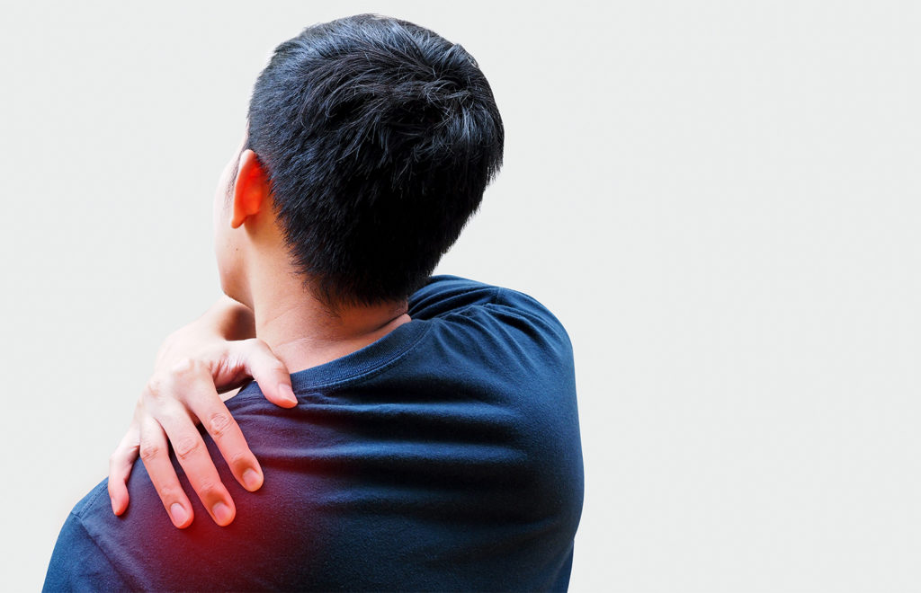man holding his shoulder due to pain