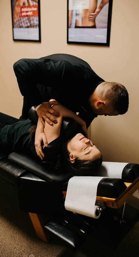 dr. andrew krueger doing thoracis adjustment on patient
