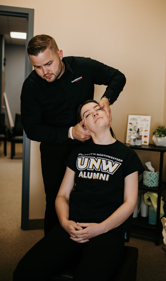 Dr. Andrew Krueger doing neck pain adjustment